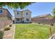 Large backyard with green grass and a fence for privacy and outdoor enjoyment at 4050 Midnight Crest Ave, North Las Vegas, NV 89031