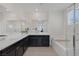Elegant bathroom featuring dual sinks, a large mirror, and a separate tub for ultimate relaxation at 4050 Midnight Crest Ave, North Las Vegas, NV 89031