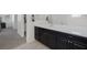Bathroom vanity featuring a bright white countertop, dark cabinetry, and ample storage space at 4050 Midnight Crest Ave, North Las Vegas, NV 89031