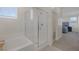 Well-lit bathroom with a glass-enclosed shower over tub, creating a modern and clean space at 4050 Midnight Crest Ave, North Las Vegas, NV 89031