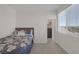 Comfortable bedroom with floral bedding, a side window, and an ensuite closet for added convenience at 4050 Midnight Crest Ave, North Las Vegas, NV 89031