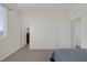 Spacious bedroom with neutral walls, plush carpeting, and multiple doorways for easy access at 4050 Midnight Crest Ave, North Las Vegas, NV 89031