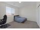 Well-lit bedroom featuring carpet, a simple bed frame, and a dedicated workspace at 4050 Midnight Crest Ave, North Las Vegas, NV 89031