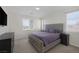 Cozy bedroom with a king-size bed, plush carpeting, and a bright view from the window at 4050 Midnight Crest Ave, North Las Vegas, NV 89031
