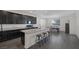 Modern kitchen with dark cabinets, granite countertops, and an island with bar seating at 4050 Midnight Crest Ave, North Las Vegas, NV 89031