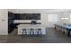 Open kitchen with dark cabinets, granite countertops, and stainless steel appliances at 4050 Midnight Crest Ave, North Las Vegas, NV 89031