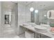 Contemporary bathroom featuring marble tile, double sinks, and stylish lighting at 4381 W Flamingo Rd # 1101, Las Vegas, NV 89103