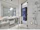 Sleek bathroom with double sinks, marble tile, and a glass-enclosed shower at 4381 W Flamingo Rd # 1101, Las Vegas, NV 89103