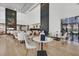 Bright dining area with high ceilings, modern decor, fireplace, and large windows at 4381 W Flamingo Rd # 1101, Las Vegas, NV 89103