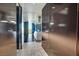 Hallway with view of kitchen area, featuring modern decor and a large window at 4381 W Flamingo Rd # 1101, Las Vegas, NV 89103