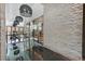 Elegant hallway with stone wall, shiny floors, wine cellar, and modern light fixtures at 4381 W Flamingo Rd # 1101, Las Vegas, NV 89103