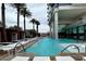 Resort-style pool with sun loungers, palm trees, and modern architecture, offering a relaxing oasis for guests at 4381 W Flamingo Rd # 1101, Las Vegas, NV 89103
