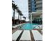 Relaxing pool area at Palms Place features lounge chairs, lush landscaping, and a modern condo building backdrop at 4381 W Flamingo Rd # 1101, Las Vegas, NV 89103
