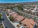 Expansive aerial view of a residential community with well-maintained homes and lush landscaping at 4607 El Camino Cabos Dr, Las Vegas, NV 89147