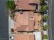 Overhead view of a home with a distinctive tile roof, landscaping, and a paved driveway at 4607 El Camino Cabos Dr, Las Vegas, NV 89147