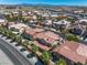 High-angle view capturing a residential area with tiled rooftops and mature palm trees at 4607 El Camino Cabos Dr, Las Vegas, NV 89147