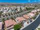Aerial view showcases a residential neighborhood with tile roofs and mature landscaping at 4607 El Camino Cabos Dr, Las Vegas, NV 89147
