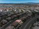 Panoramic aerial view of a vast suburban area with diverse home styles and mountain views at 4607 El Camino Cabos Dr, Las Vegas, NV 89147