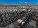 Sweeping aerial shot featuring homes set against a backdrop of mountains and a clear blue sky at 4607 El Camino Cabos Dr, Las Vegas, NV 89147