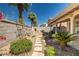 Home exterior with a covered patio and desert landscaping in the backyard at 4607 El Camino Cabos Dr, Las Vegas, NV 89147