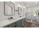Modern bathroom with dual sinks, stylish fixtures, and a sleek glass-enclosed shower at 4607 El Camino Cabos Dr, Las Vegas, NV 89147