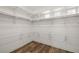 Spacious walk-in closet with ample shelving and wood flooring at 4607 El Camino Cabos Dr, Las Vegas, NV 89147