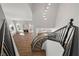 Bright foyer featuring a curved staircase and an overview of the living room with fireplace at 4607 El Camino Cabos Dr, Las Vegas, NV 89147