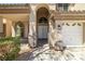 The arched entryway with double doors and two car garage is perfect for welcoming guests at 4607 El Camino Cabos Dr, Las Vegas, NV 89147