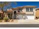 Charming two-story home with a red tile roof, manicured landscaping, and a spacious two-car garage at 4607 El Camino Cabos Dr, Las Vegas, NV 89147