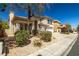 Two-story home featuring a front yard with desert landscaping, and a two-car garage at 4607 El Camino Cabos Dr, Las Vegas, NV 89147