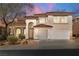 Elegant two-story home with a red tile roof, arched entryway, and a spacious two-car garage at 4607 El Camino Cabos Dr, Las Vegas, NV 89147
