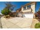 Inviting two-story home featuring a two-car garage, desert landscaping, and a manicured lawn at 4607 El Camino Cabos Dr, Las Vegas, NV 89147