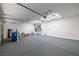 Spacious garage with modern lighting and epoxy-coated flooring at 4607 El Camino Cabos Dr, Las Vegas, NV 89147