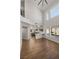 Open living space with high ceilings, hardwood floors, and a view of the modern kitchen at 4607 El Camino Cabos Dr, Las Vegas, NV 89147