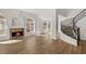 Spacious living room featuring a fireplace, hardwood floors, and staircase at 4607 El Camino Cabos Dr, Las Vegas, NV 89147