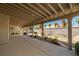 Expansive covered patio overlooking a backyard with desert landscaping and a rock garden at 4607 El Camino Cabos Dr, Las Vegas, NV 89147