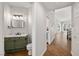 Stylish powder room with green vanity, marble countertop, and modern lighting at 4607 El Camino Cabos Dr, Las Vegas, NV 89147