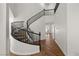 Elegant winding staircase with black railing and neutral carpet treads at 4607 El Camino Cabos Dr, Las Vegas, NV 89147