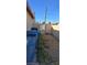 Side yard with trash receptacles and gated access to alley at 4690 E California Ave, Las Vegas, NV 89104