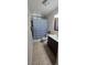 Cozy bathroom featuring a shower with curtain, toilet and vanity with dark brown cabinets at 4690 E California Ave, Las Vegas, NV 89104