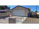 Exterior shot of home's one-car garage and driveway featuring a secure fence at 4690 E California Ave, Las Vegas, NV 89104