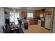 Well-lit eat-in kitchen boasts wooden cabinets, granite counters, and a sliding glass door to the backyard at 4690 E California Ave, Las Vegas, NV 89104