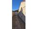 Side yard featuring a narrow gravel walkway alongside home at 4690 E California Ave, Las Vegas, NV 89104