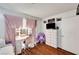 Bright bedroom features a vanity with a lighted mirror and hard wood floors at 4835 Nevada Ave, Las Vegas, NV 89104