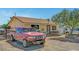 View of a single story house with a truck and vehicles in the front and a chain link fence at 4835 Nevada Ave, Las Vegas, NV 89104