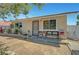 Close view of a single story house with front entrance, potted plants and seating area at 4835 Nevada Ave, Las Vegas, NV 89104