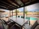 Covered back patio with a dining table for 8, pool, patio furniture, and fire pit creates a relaxing outdoor space at 4881 E Imperial Ave, Las Vegas, NV 89104