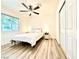 Bright bedroom with laminate floors, closet, ceiling fan and natural light streaming through the window at 4881 E Imperial Ave, Las Vegas, NV 89104