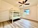 Bedroom with a bunk bed, modern flooring, ceiling fan and plenty of natural light from the window at 4881 E Imperial Ave, Las Vegas, NV 89104