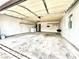 Spacious two-car garage featuring laundry area, overhead door, shelving, and plenty of room for storage at 4881 E Imperial Ave, Las Vegas, NV 89104